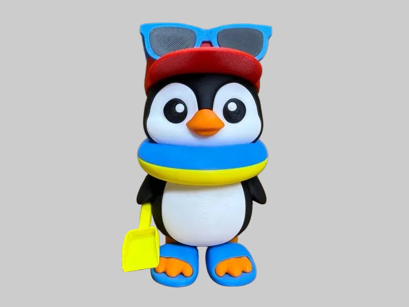 Mr Penguin Beach – 12 cm 3D printed penguin with blue sunglasses, red cap, float and spade